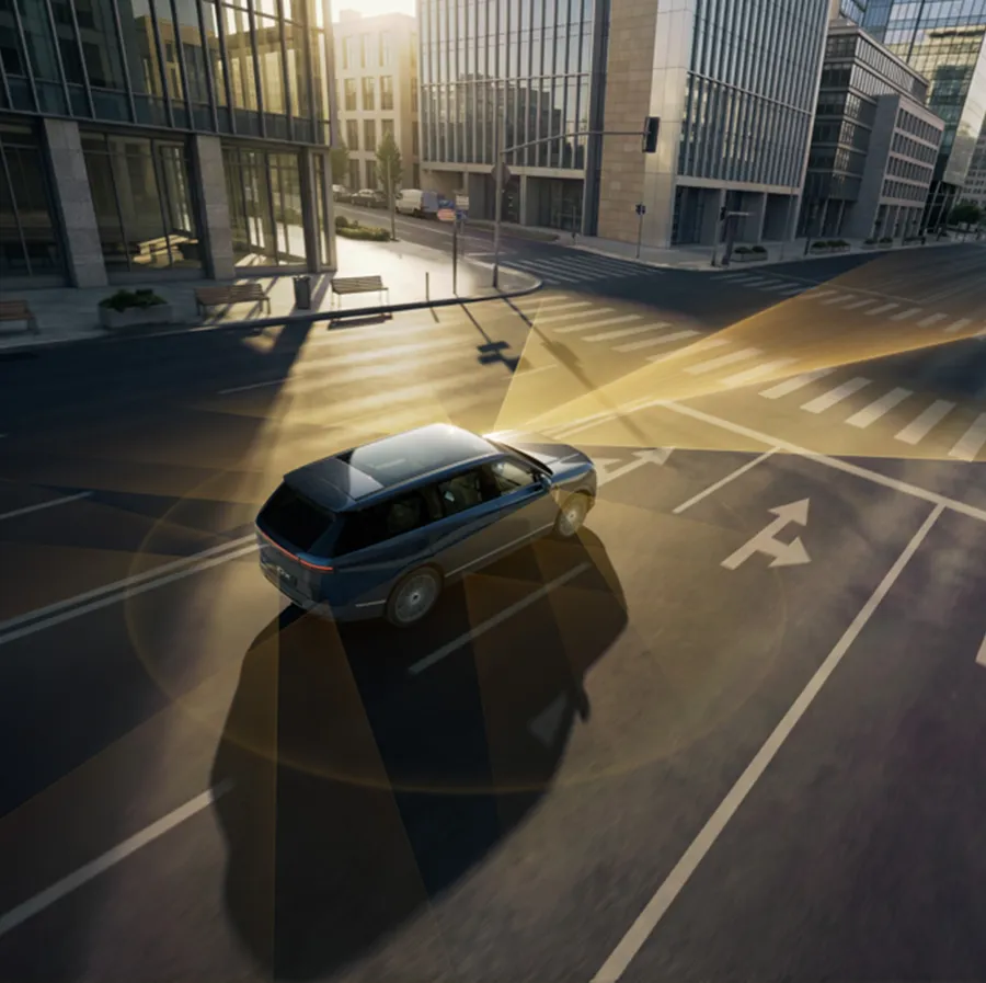 Illustration of an XPeng vehicle at an urban intersection with 360-degree sensor coverage fields projected around it
